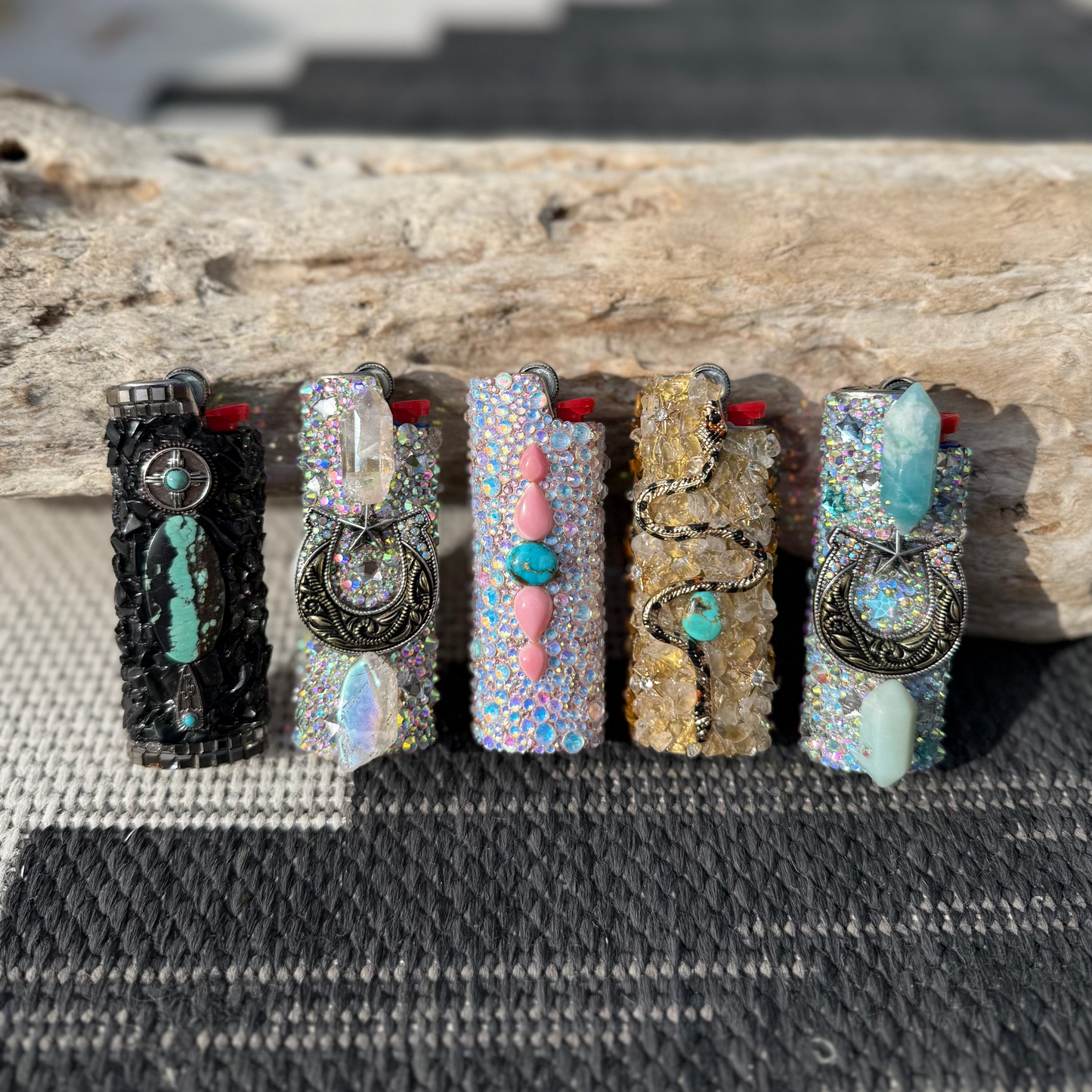 Five decorative cases with unique designs on a textured surface