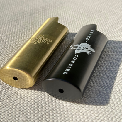 Gold and black cylindrical objects with branding on a textured surface