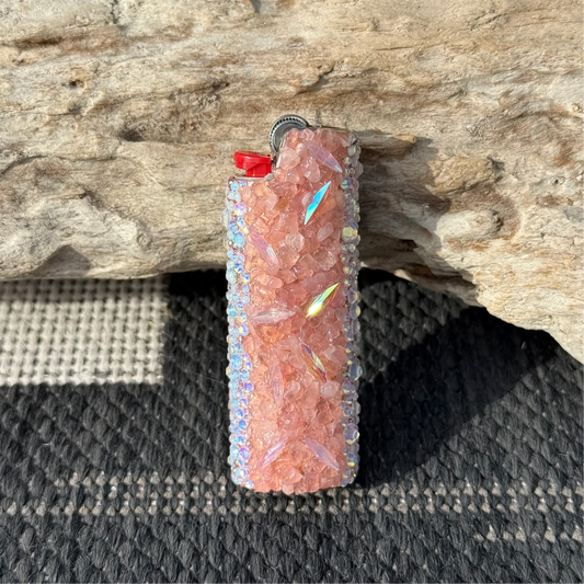 Decorative lighter with gemstones on a wooden surface